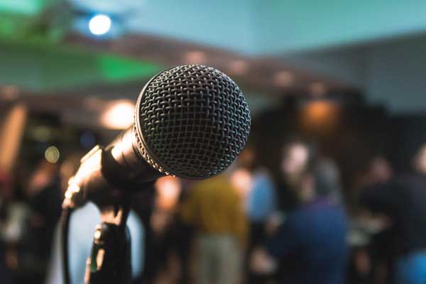 Speaker presenting at a podium with a microphone