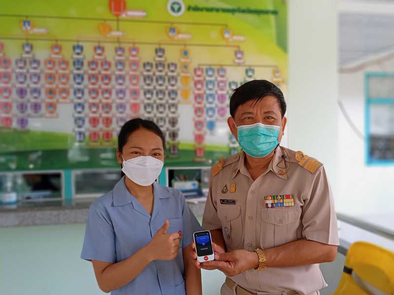 Staff at Samut Sakhon Provincial Public Health Office using Pocketalk to communicate with foreign nationals